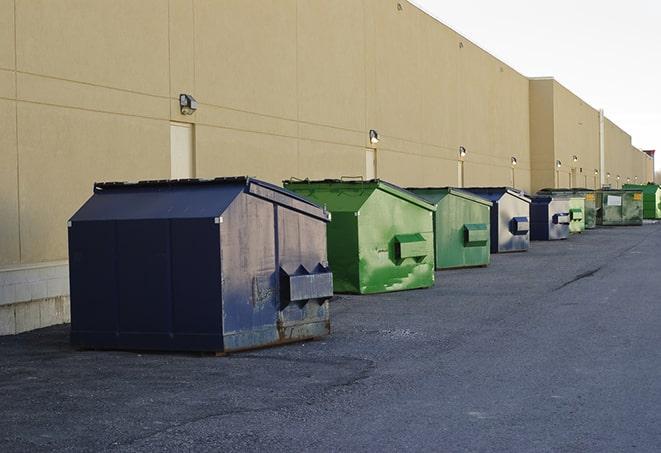 construction crew disposing of building materials in large bins in Avon By The Sea